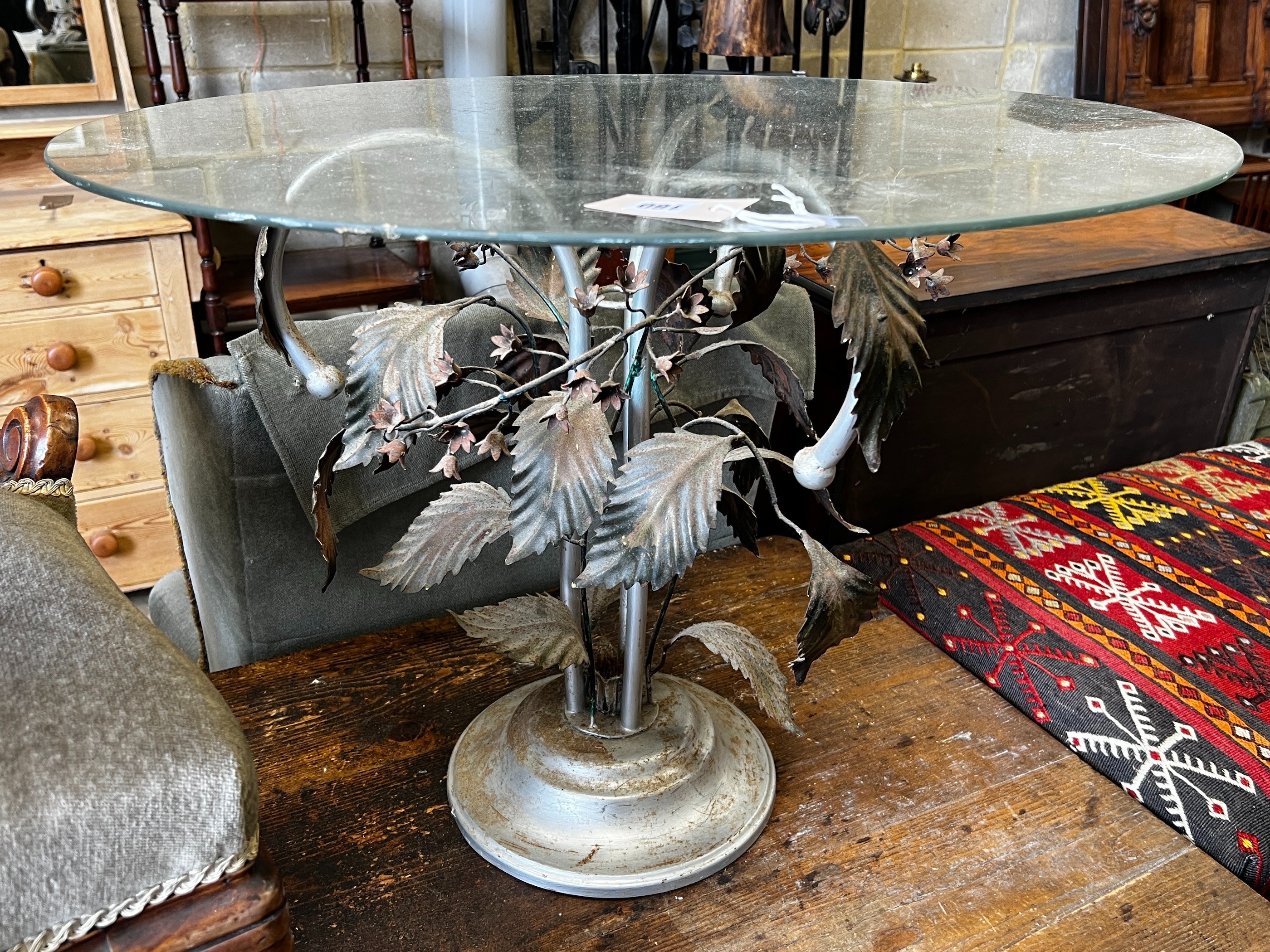 A circular glass topped coffee table on metal underframe, diameter 76cm, height 56cm